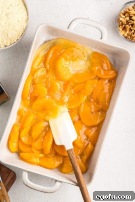 Two cans of peach pie filling in a baking dish.