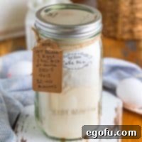 A jar of Homemade Yellow Cake Mix with a tag including instructions.