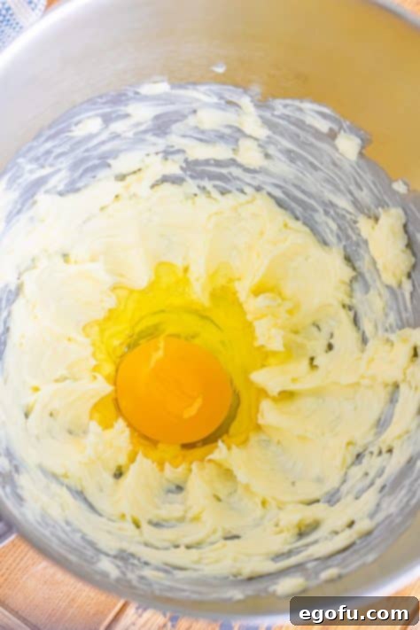 Whipped butter and an egg in a bowl.