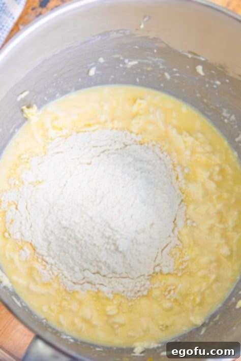 Dry cake mix and wet ingredients to make a cake batter in a bowl.