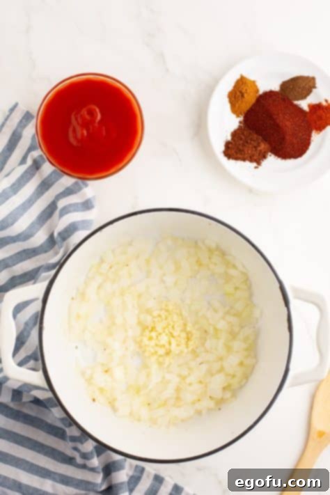 Cincinnati's Signature Chili 11 Onions and oil in a pan.