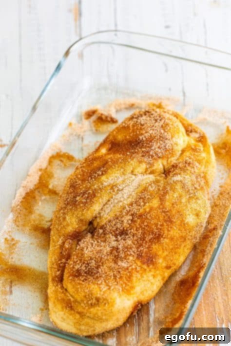 A cinnamon and sugar coated raw loaf of bread.