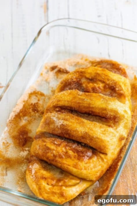 A cut raw loaf of bread with cinnamon and sugar.