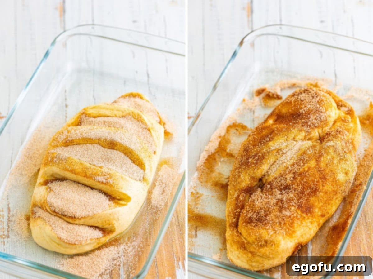 A raw bread loaf covered in cinnamon sugar, with a focus on the coated slits, ready for more layers.