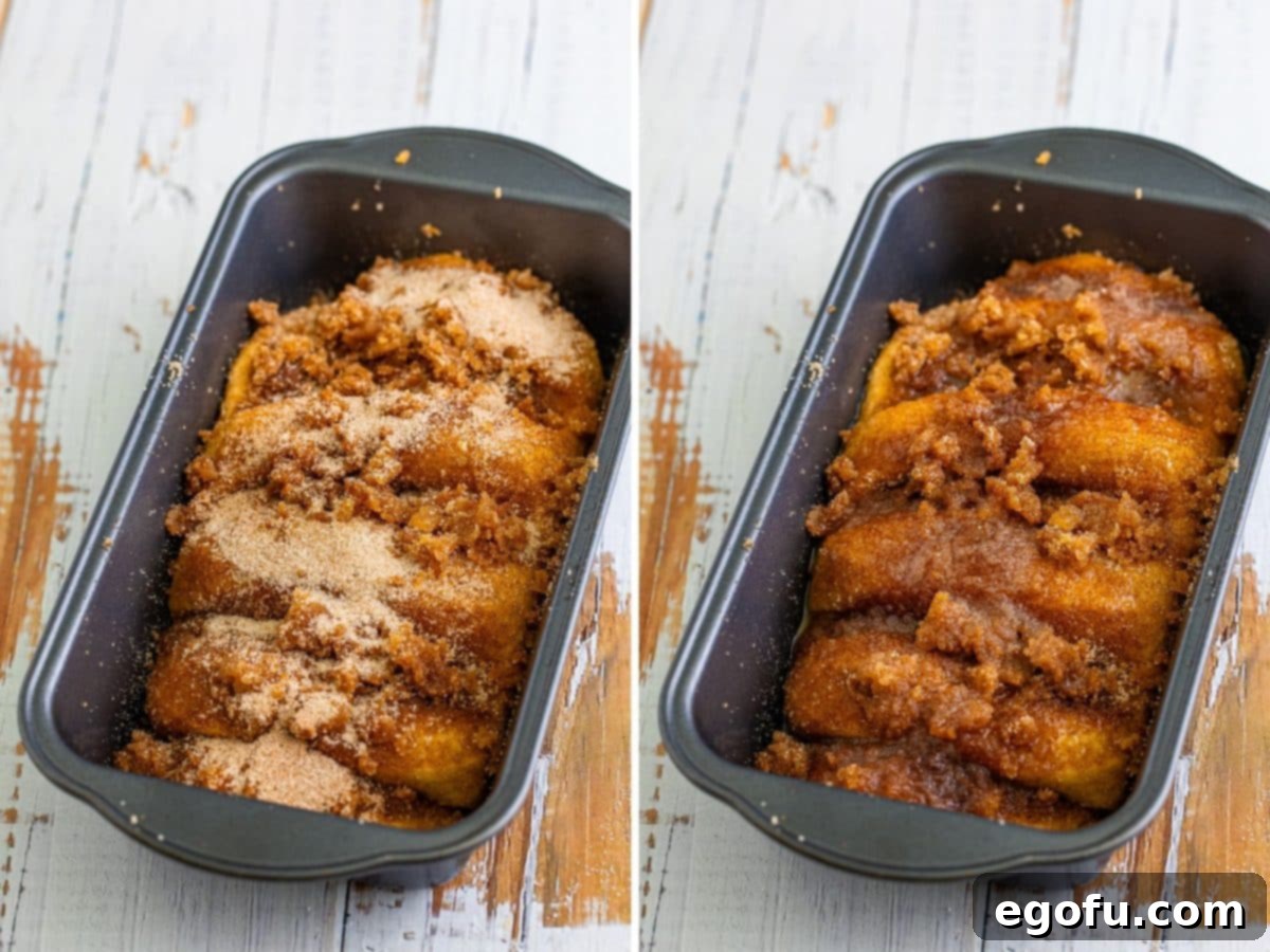 A raw loaf of cinnamon bread nestled in a baking pan, generously covered with cinnamon sugar, ready to rise.