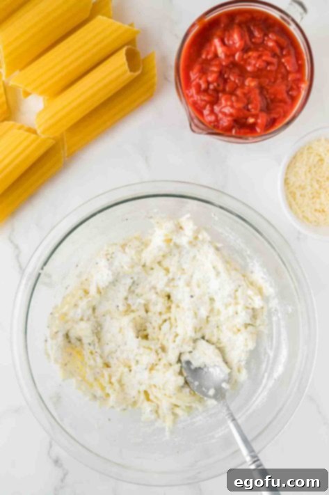 Effortless Manicotti 11 A bowl with ricotta, egg, 2 cups of the mozzarella cheese, ¼ cup of the parmesan cheese, and the Italian seasoning.