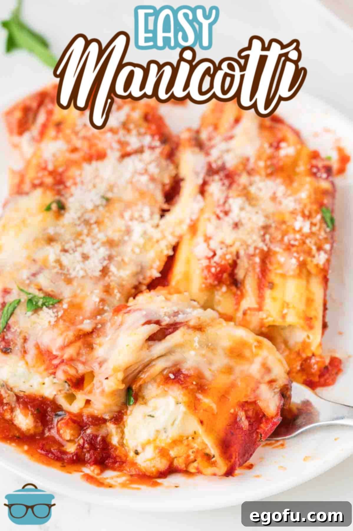 Effortless Manicotti 3 A close-up of a single portion of Easy Manicotti on a white plate, showing the rich filling and melted cheese.