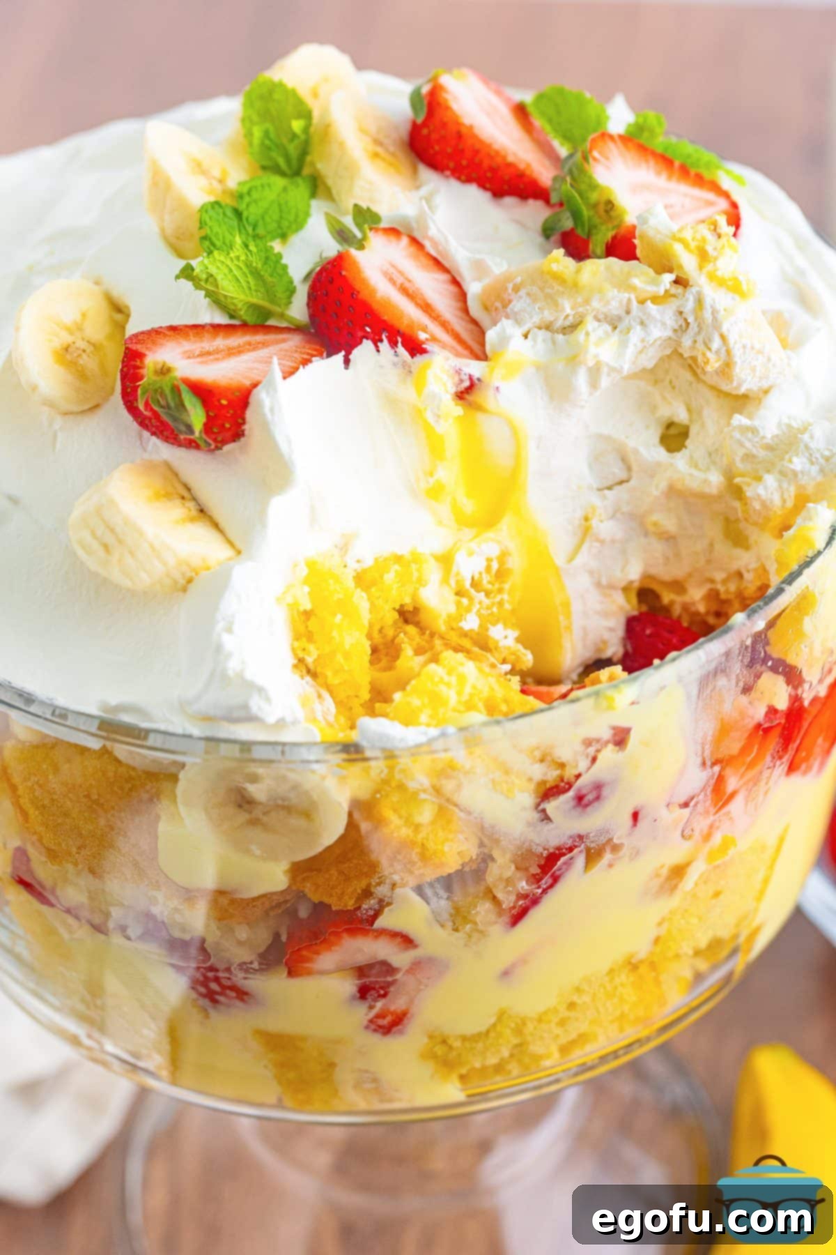 Party Perfect Bowl Cake 9 A perfectly prepared Punch Bowl Cake, presented beautifully, with a slice already removed to showcase its intricate and appetizing layers.