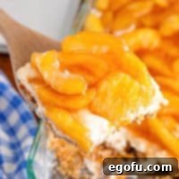 A serving of Apple Pretzel Salad above the rest of the dish of it.