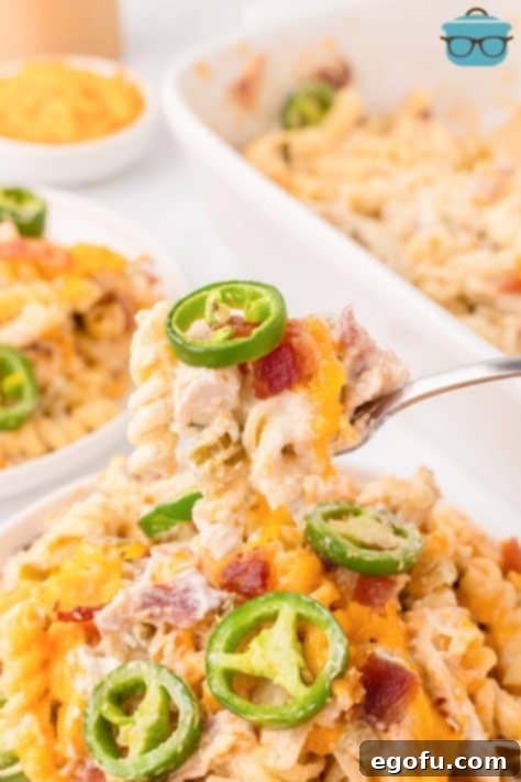 A bite of Chicken Jalapeno Popper Casserole on a fork.