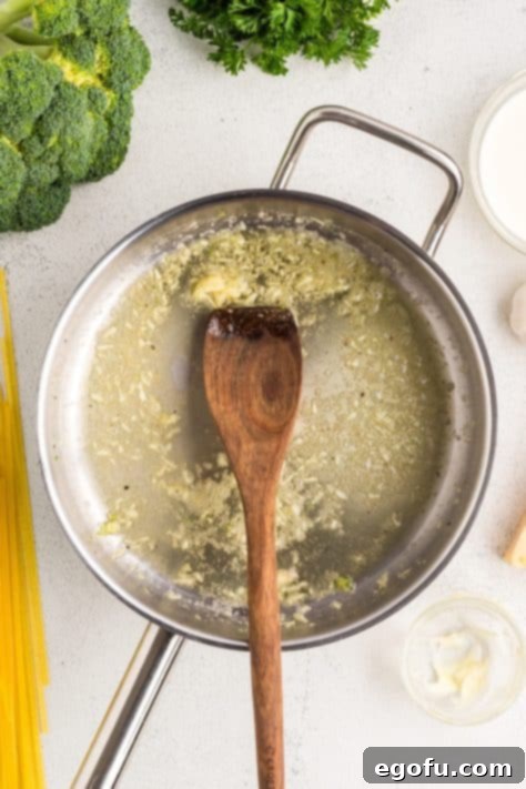 Butter melting with minced garlic in a hot pan.