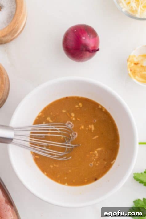 A bowl with onion soup, beef broth, and Dijon mustard.