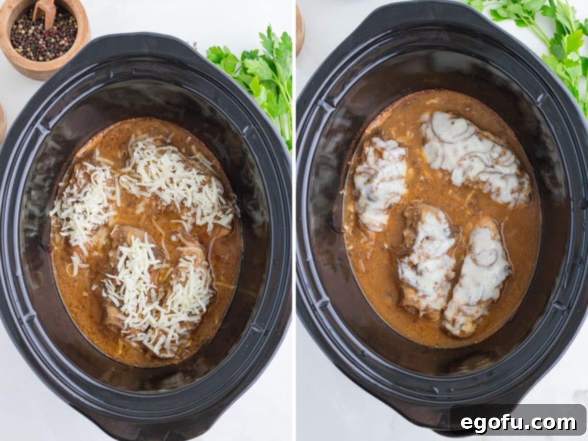 Melted cheese on top of chicken in a slow cooker.