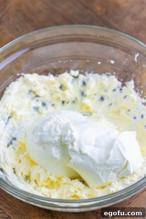 Cream cheese and sour cream mixed together in a bowl.