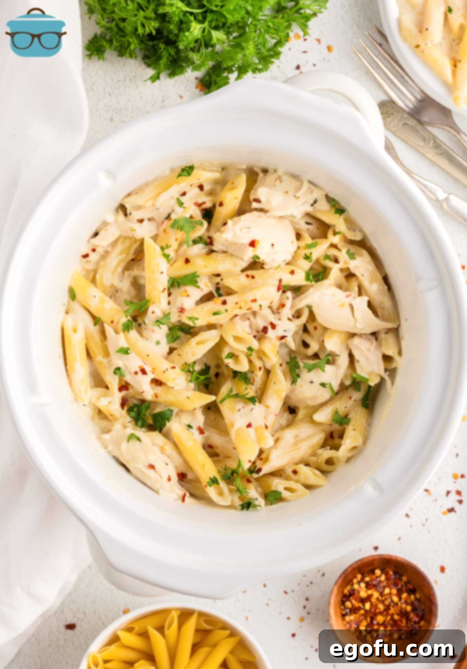 Creamy Slow Cooker Garlic Parmesan Chicken Pasta 7 Looking down on a full bowl of Garlic Parmesan Chicken Pasta, ready to be enjoyed.