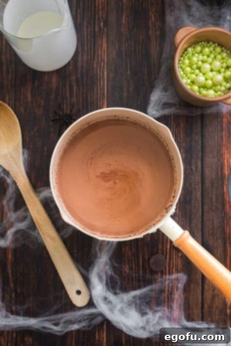 Bewitching Brew Hot Chocolate 10 Homemade hot chocolate simmering in a saucepan after the chocolate wafers have melted.