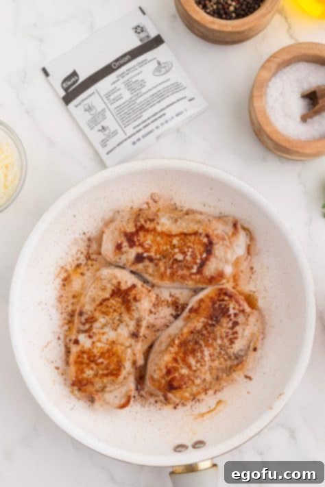 Caramelized Onion Smothered Pork Chops 12 Seasoned pork chops cooking.