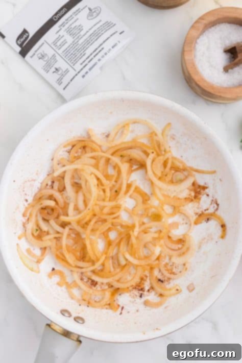 Caramelized Onion Smothered Pork Chops 13 Onions cooking in skillet.