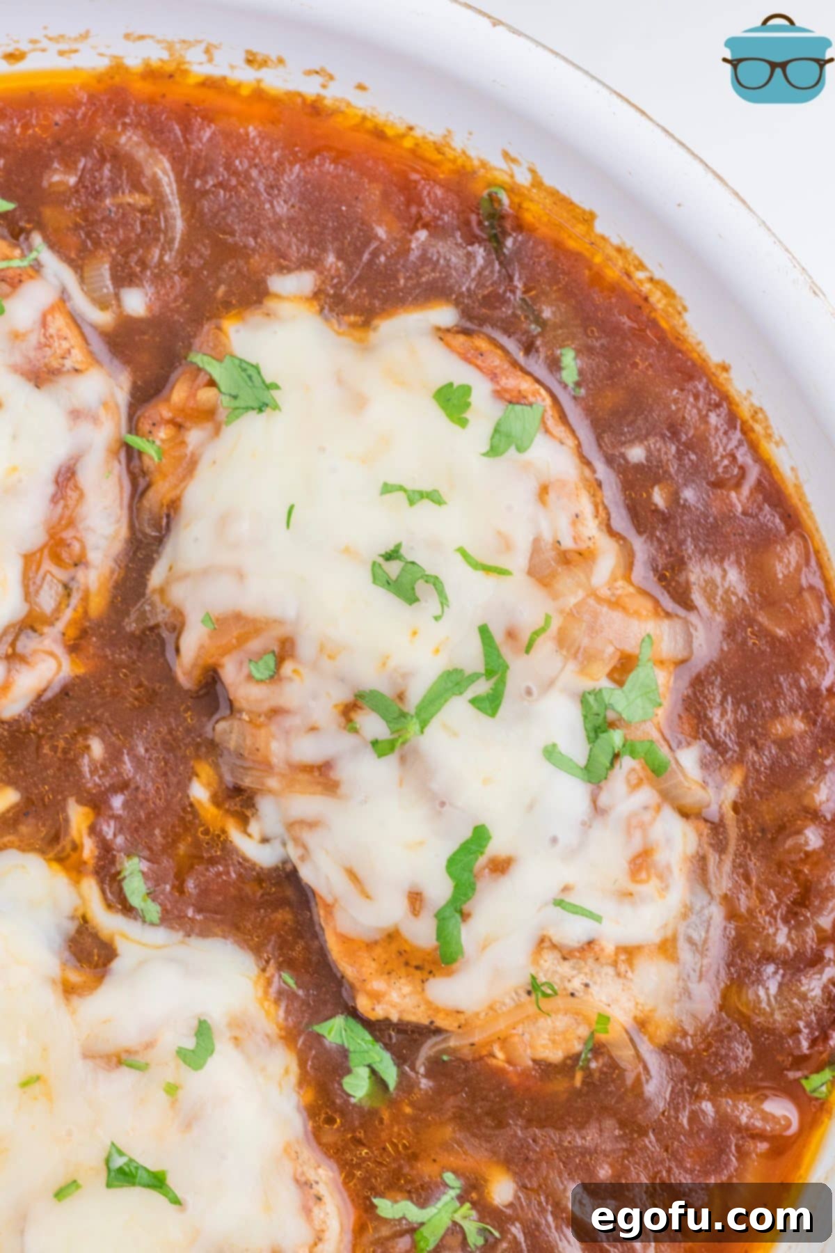 Caramelized Onion Smothered Pork Chops 10 Looking down on a few French Onion Pork Chops with cheese and gravy.