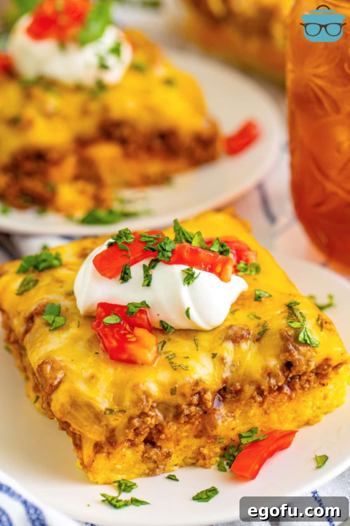 A serving of Tamale Pie on a plate, showcasing the distinct layers of cornbread, seasoned beef, and melted cheese.