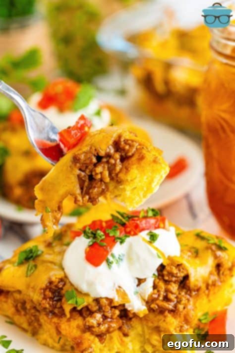 A fork holding a bite of Tamale Pie.