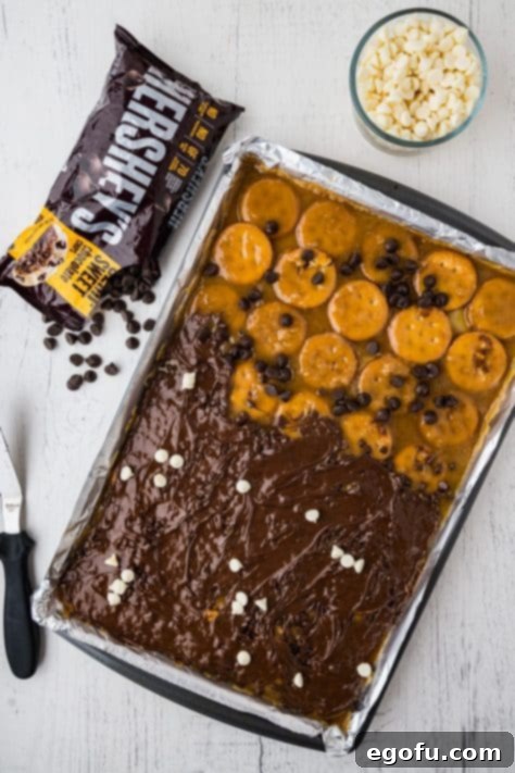 Decadent Strawberry Chocolate Bark 13 Chocolate and caramel covered Ritz on a sheet pan.