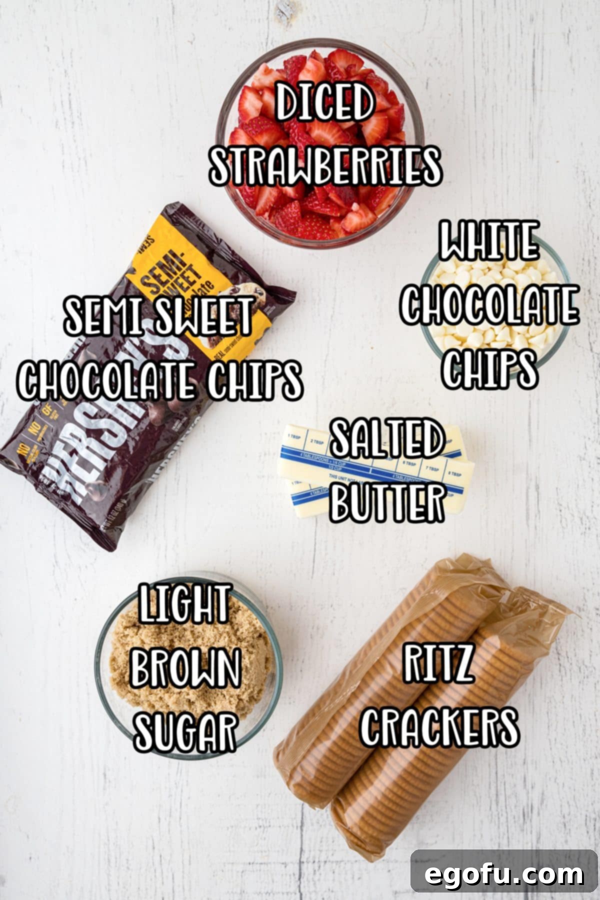 Decadent Strawberry Chocolate Bark 4 A flat lay image showing all the fresh ingredients: Semi-sweet chocolate chips, white chocolate chips, Ritz crackers, light brown sugar, strawberries and butter.