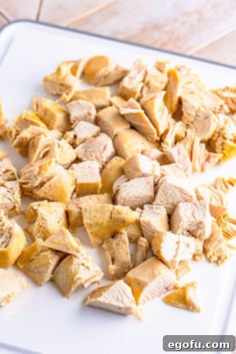 Cooked chicken breast removed from the slow cooker, ready for dicing.