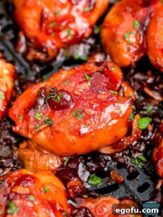 Looking down closely at a few pieces of Air Fryer Cranberry Chicken Thighs.