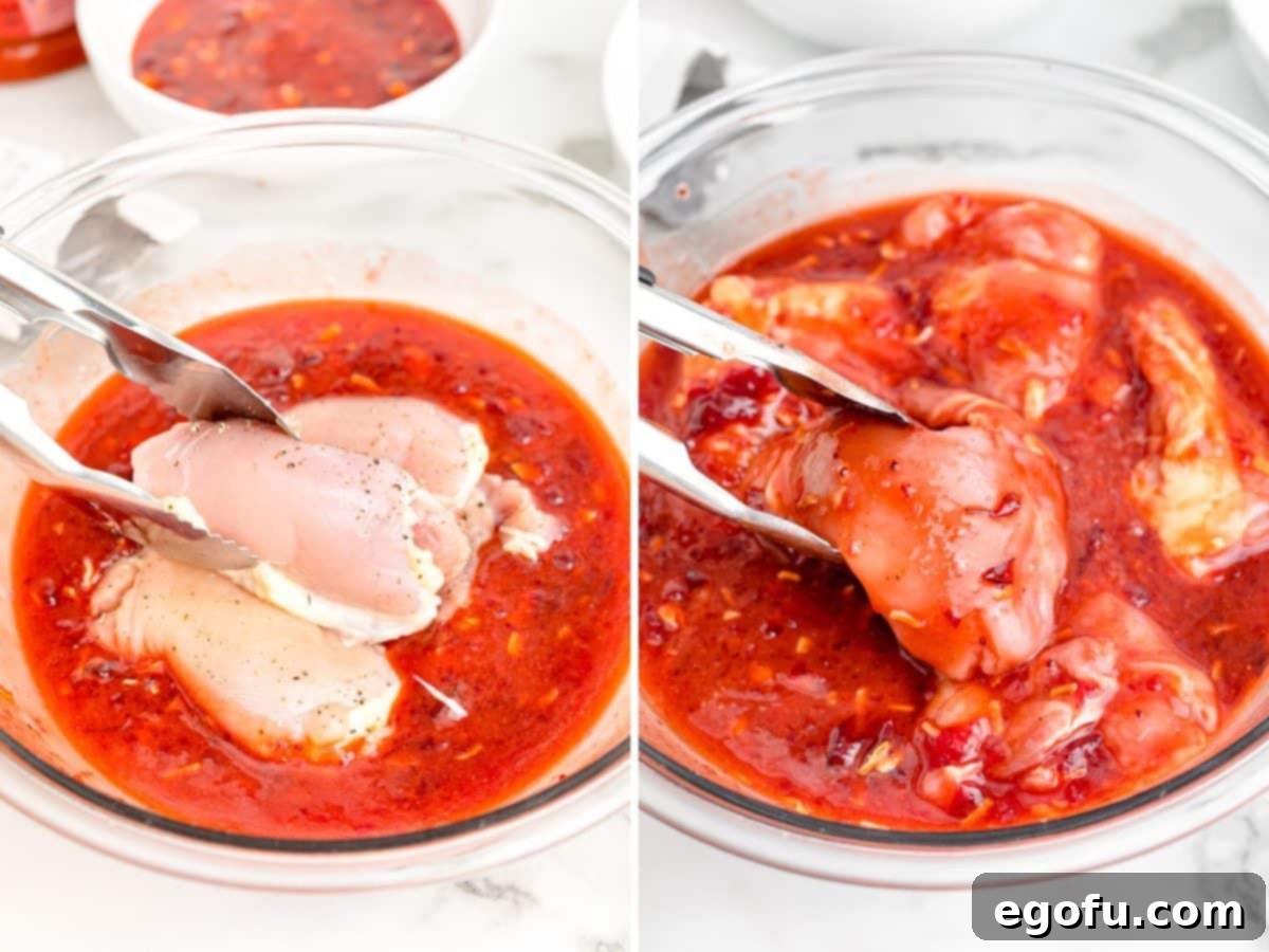 Chicken thighs being added to a sauce and tongs flipping the chicken to coat it better in the sauce.