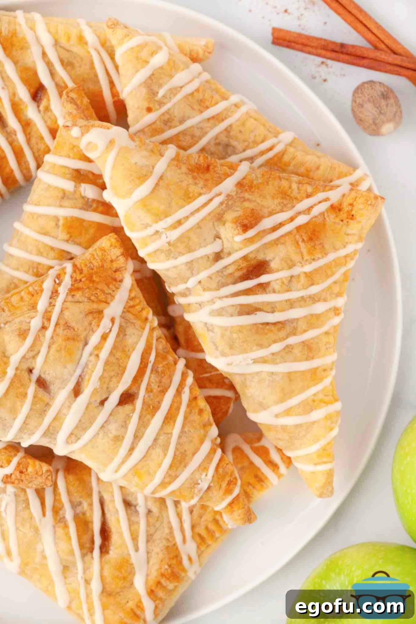 A plate of Apple Turnovers with a simple glaze, inviting and delicious.