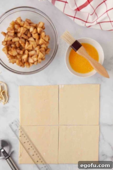 Puff pastry rolled out and precisely cut into pieces.
