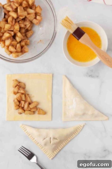 Apple filling on a piece of puff pastry, ready to be folded.