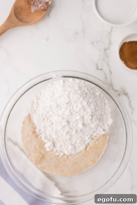 Flour being added to a bowl.