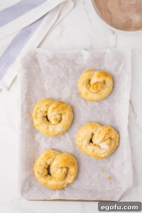 Baked pretzels on a baking sheet.