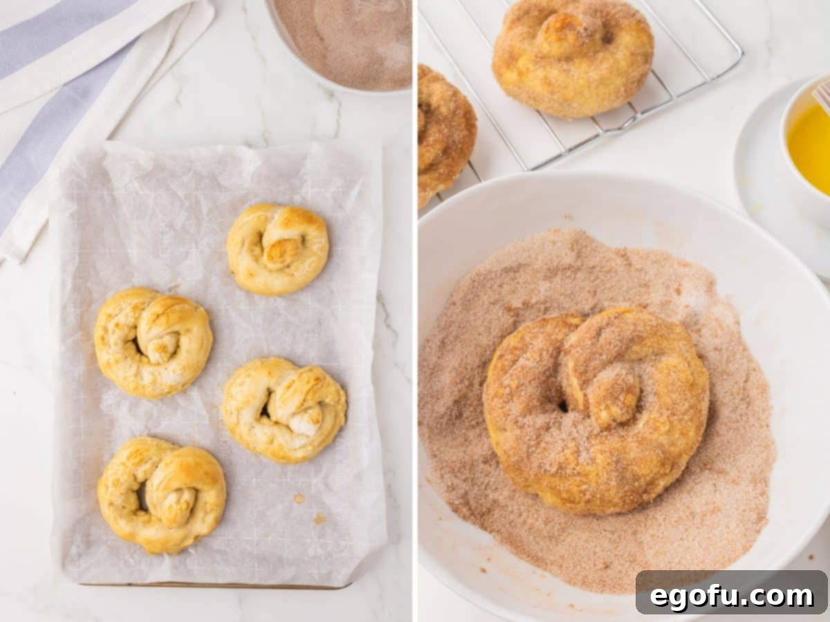A few freshly baked pretzels on a baking sheet, displaying a golden crust.