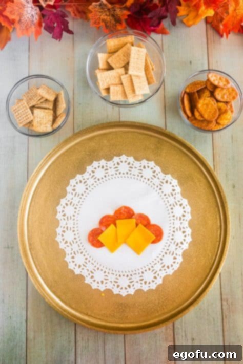 Cheddar and pepperoni on a plate.