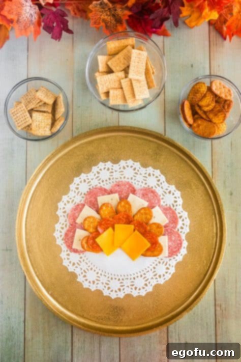 Pepper jack cheese, cheddar cheese, crackers and pepperoni on a platter.