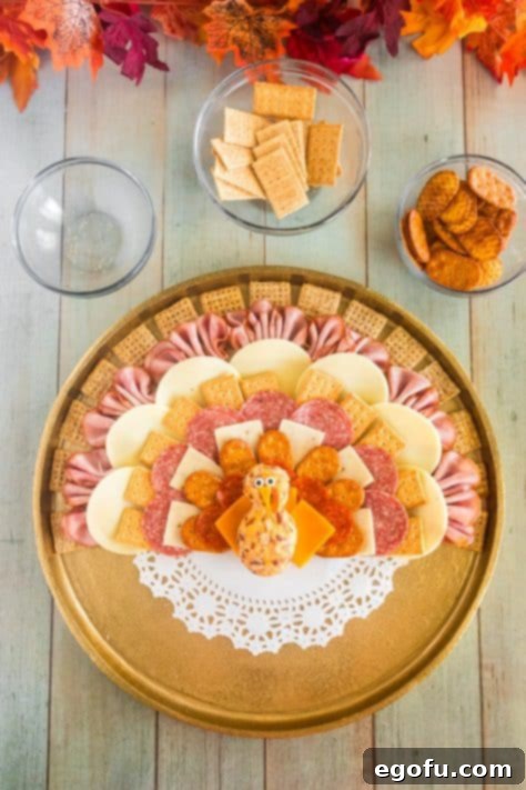 Eyes being added to turkey cheeseball bodyy.