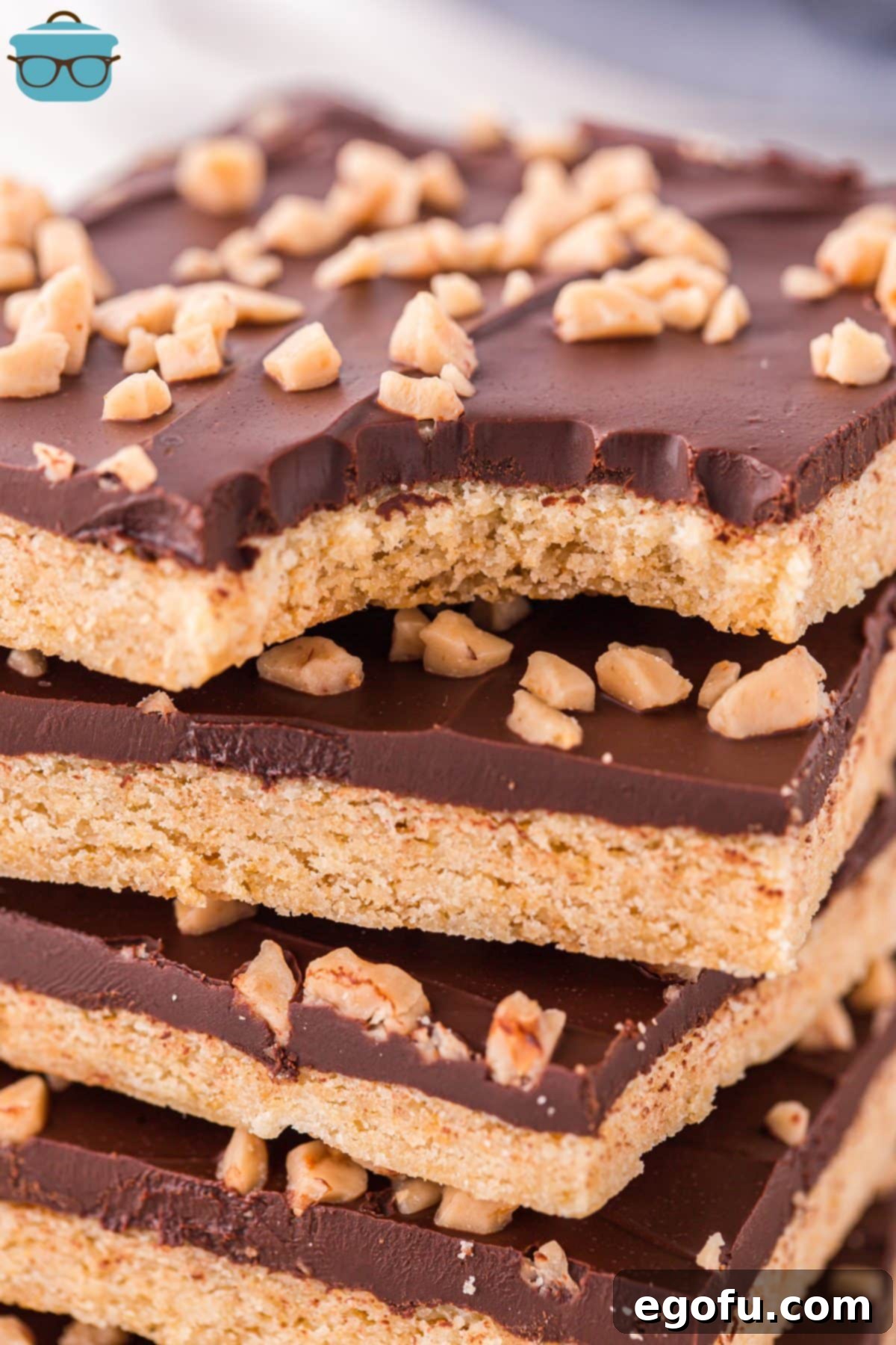 Effortless Toffee Squares 7 A Toffee Bar with a bite taken out and a few others in a stack.