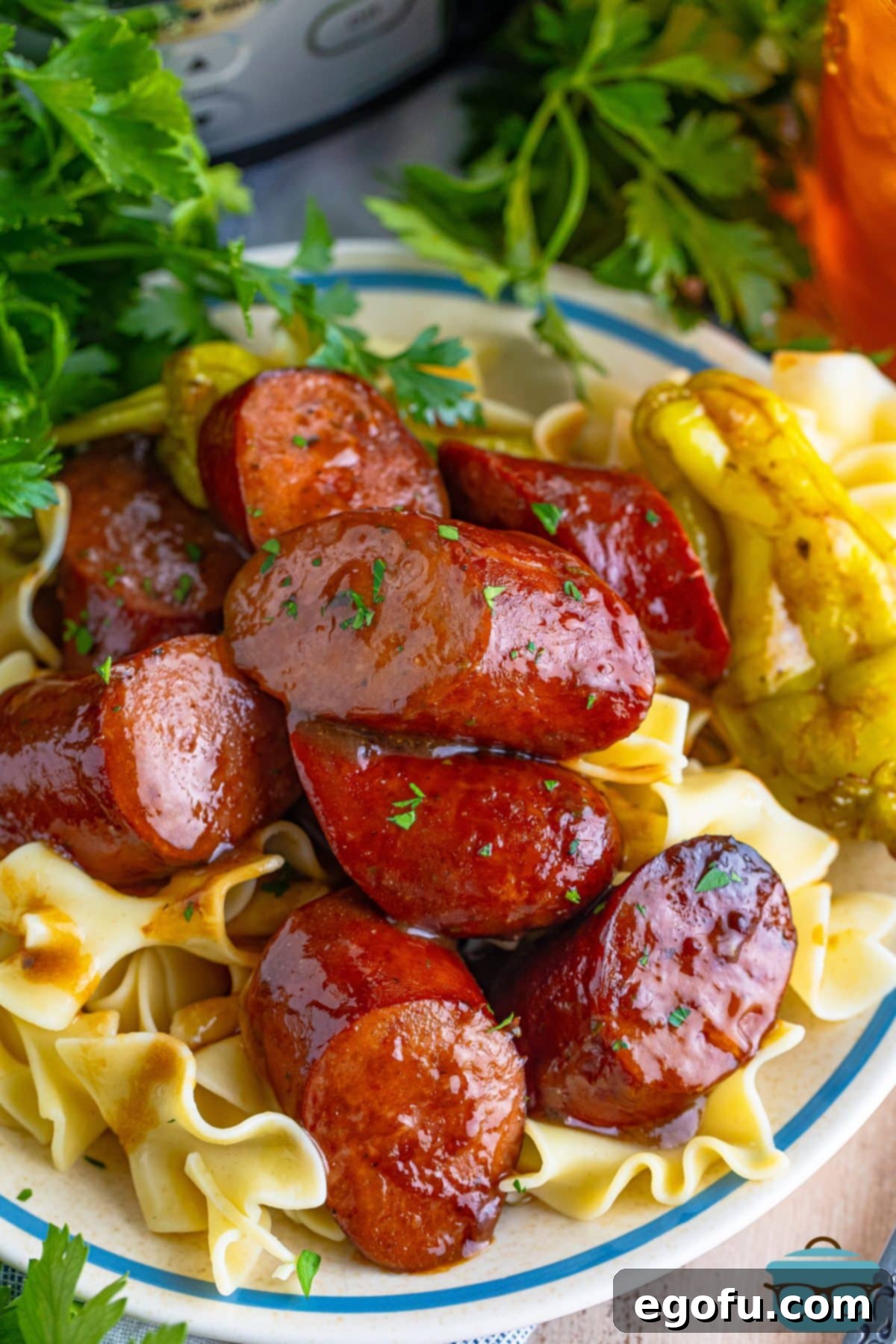 Looking down on a plate of pasta and cut up Slow Cooker Mississippi Kielbasa.