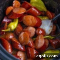 Looking down into a Crock Pot with Mississippi Kielbasa cut up.