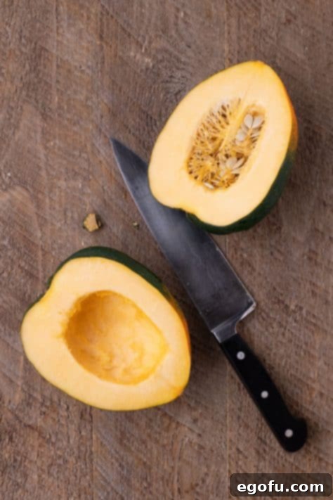 Perfectly Roasted Air Fryer Acorn Squash 11 An Acorn Squash cut in half with the knife.