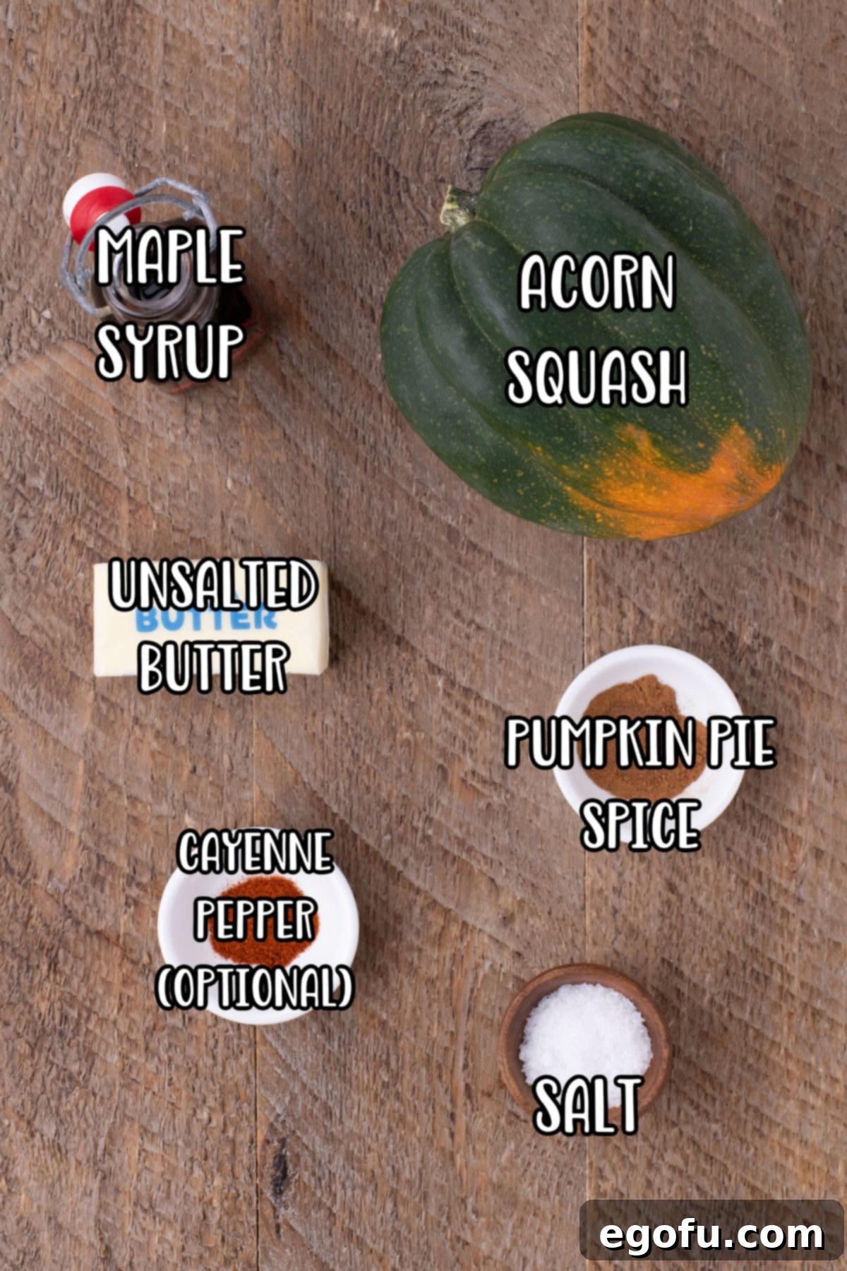 Perfectly Roasted Air Fryer Acorn Squash 4 A vibrant flat lay showcasing all the fresh ingredients needed for Air Fryer Acorn Squash: a whole acorn squash, unsalted butter, cayenne pepper, maple syrup, pumpkin spice, and salt.