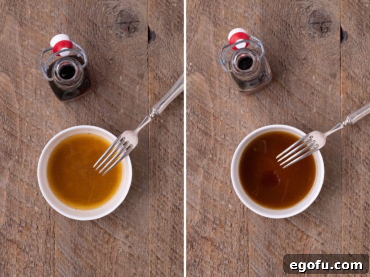 Perfectly Roasted Air Fryer Acorn Squash 5 A fork in a bowl of butter, maple syrup, salt, pumpkin spice, and cayenne pepper with another bowl nearby showing the whisked mixture, highlighting the glaze preparation.