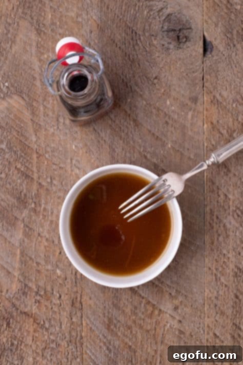 Perfectly Roasted Air Fryer Acorn Squash 10 A butter mixture in a bowl with a fork.