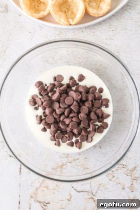 Chocolate chips and heavy cream in a bowl.