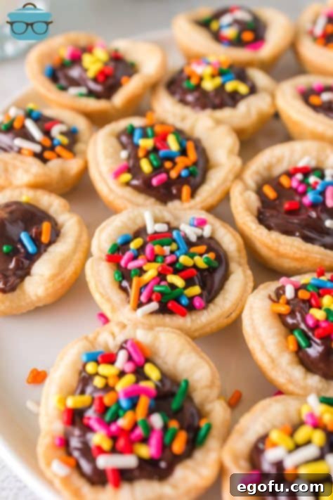 A top-down view of several finished Buckeye Mini Pies adorned with colorful sprinkles, ready for serving.