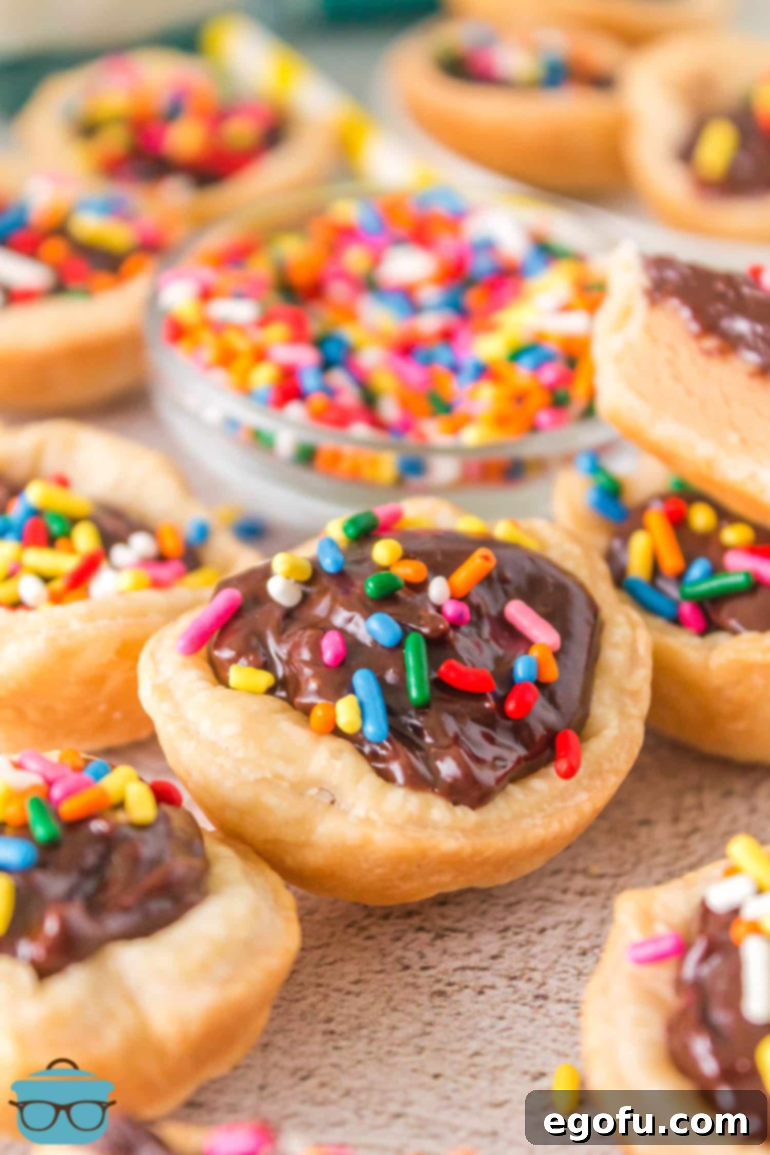 A cluster of beautifully finished Buckeye Mini Pies, topped with colorful sprinkles, presented attractively for serving.