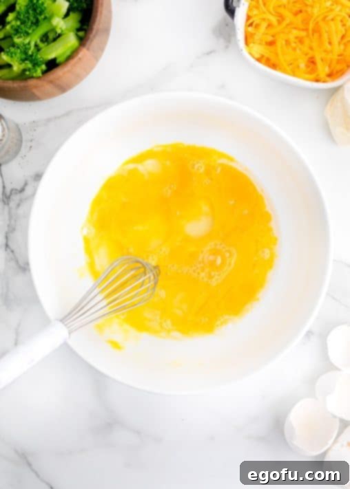 Homestyle Broccoli Cheddar Cornbread 11 Whisked eggs in a bowl.
